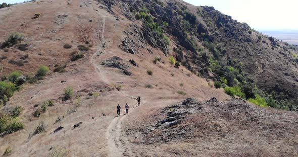 Hikers Walking In The Trail At Macin Mountain Range On A Sunny Summer Day alt