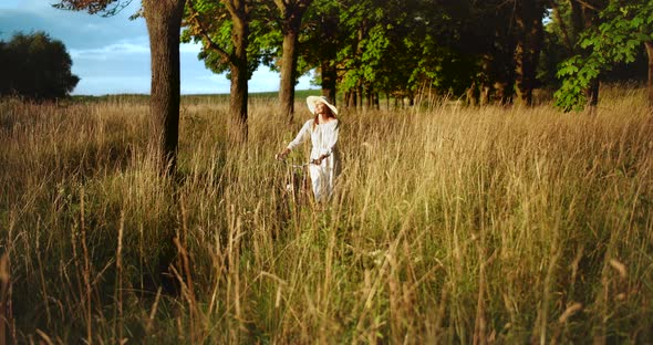 Woman Walking with Bicycle Countryside