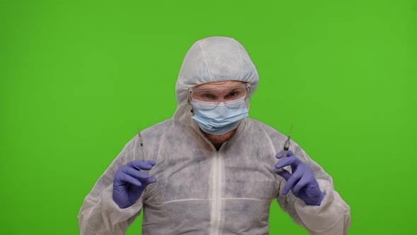 Crazy Doctor in PPE Protective Suit with Two Syringes Dancing Fooling Around Making Silly Faces alt