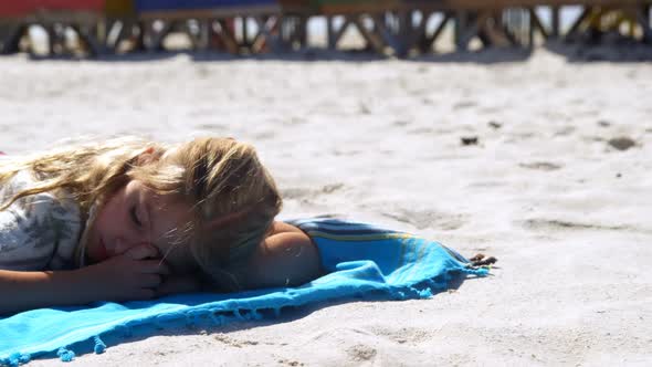 Girl sleeping in the beach  alt