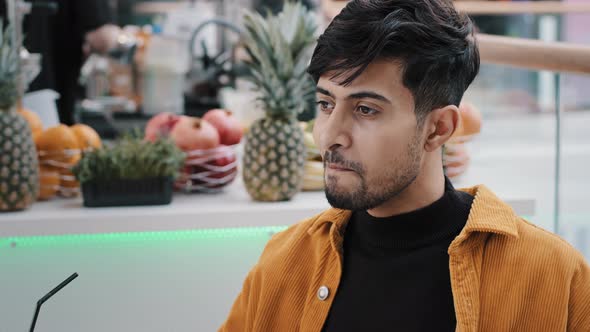 Young Hispanic Male Cafe Client Resting Spending Weekend Drinking Exotic Drink From Plastic alt