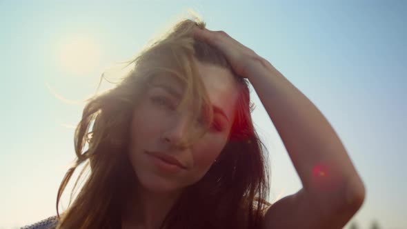 Portrait of Woman Looking Straight at Camera in Light alt