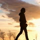 Slow motion of a thin woman silhouette walking at sunset in a park in Istanbul. - VideoHive Item for Sale