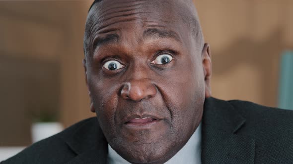 Extreme Closeup Old Wrinkled Emotional Businessman African American Scared Shocked Amazed Biracial alt