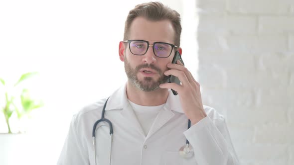 Portrait of Doctor Talking on Phone alt