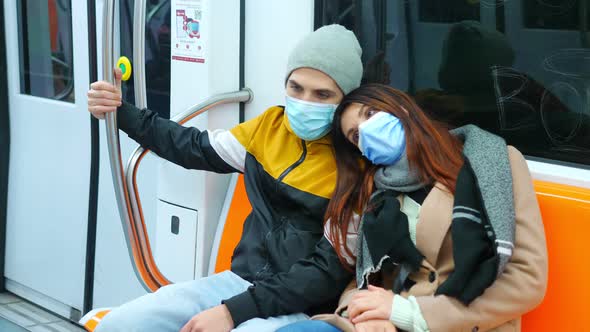 covid19, pandemic - young couple wearing mask on subway alt