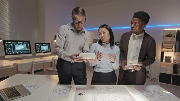Three Engineers Discussing D Printed Car Model alt