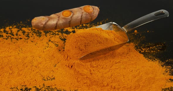 Turmeric, curcuma longa, Root falling on curcuma Powder, Indian Spice, Slow Motion 4K alt