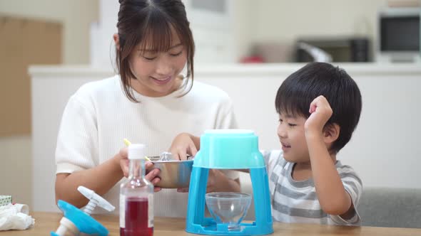 Parent and child making shaved ice alt