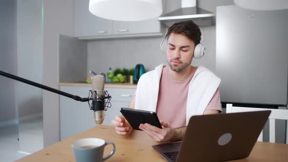 Young Man Streamer Makes a Live Podcast for Social Networks Remotely Working While Sitting in the alt