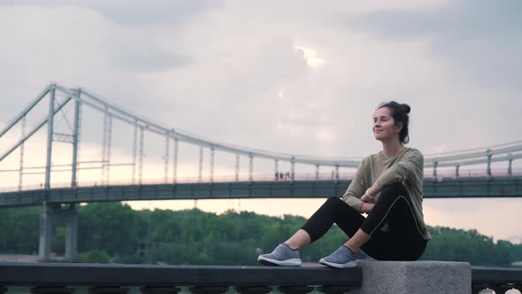 Girl in Sportswear on a Background of the City