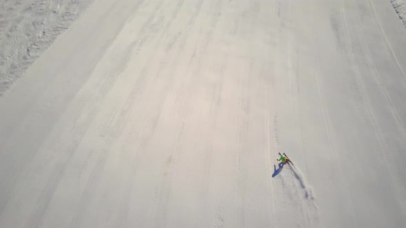 Following Skier on Ski Slope With Drone
