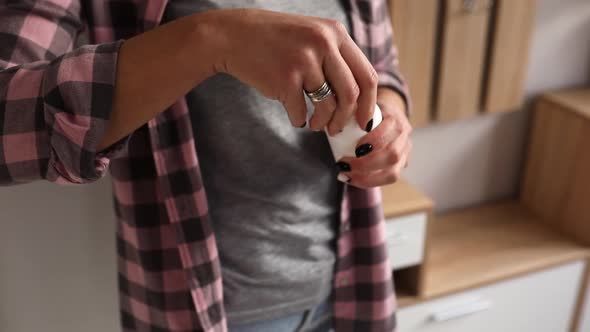 Woman open a bottle with pills vitamins or drugs tablets alt