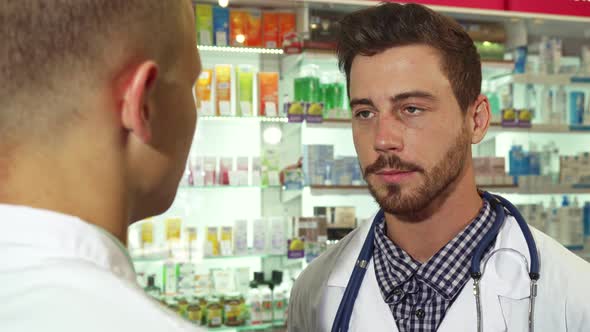 Doctor Talking To Patient at Drugstore