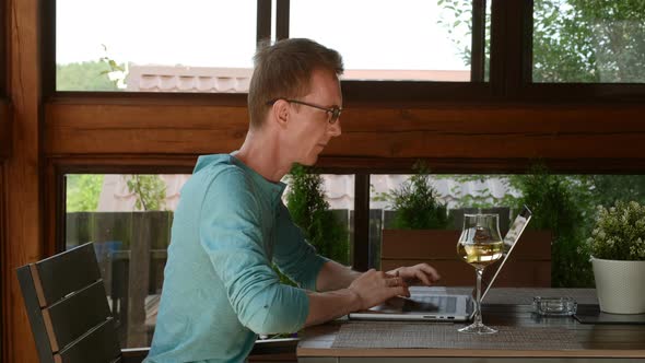Man Typing On Laptop While Being On Vacations