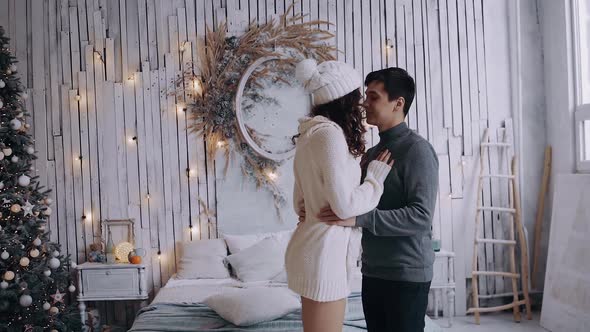 Large Frame with a Couple Sitting Face To Face at Home Near the Bedroom and Smiling. alt