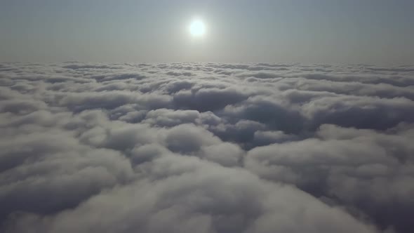 View From a Drone on a Sea of Clouds to the Horizon at Dawn alt