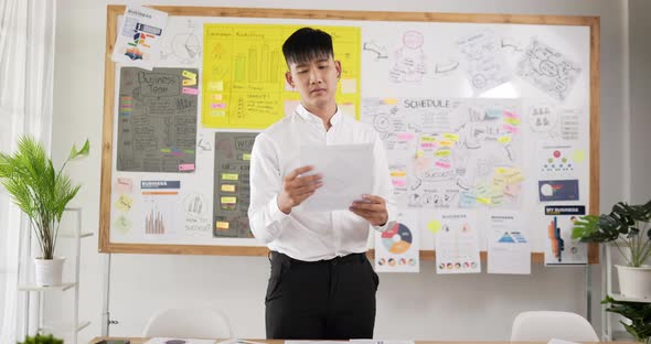 Man picked up the document and was dissatisfied alt