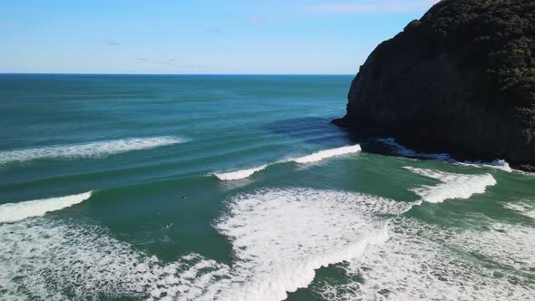 Surf break at Piha black sand beach alt