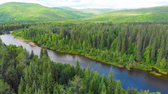 4K Drone Video of Beautiful Bend in the Chena River as it runs through Pine Tree Covered Mountains n alt