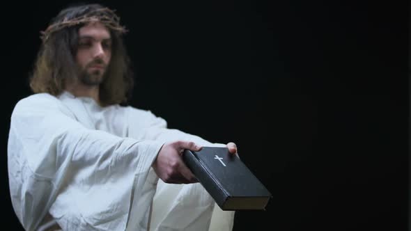 Messiah Giving Bible to Man on Dark Background, Holy Scripture, Religious Help alt