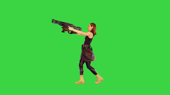 Gamecharacter Girl Walks with Machine Guns Shooting with Both Hands on a Green Screen Chroma Key