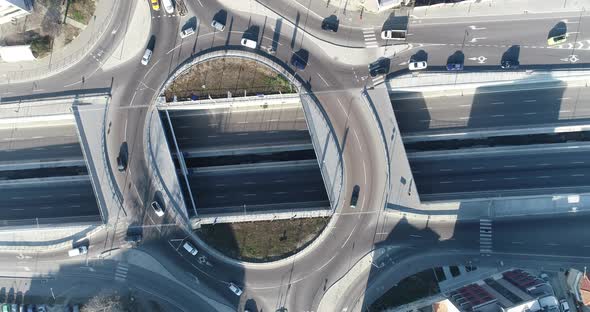 Top down view round road junction in the center. Circle road on two levels. Street traffic alt
