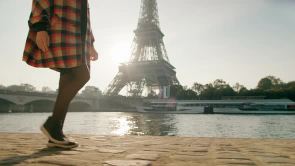 Woman in Dress and Sneakers Walks in Paris France Eiffel Tower at Background