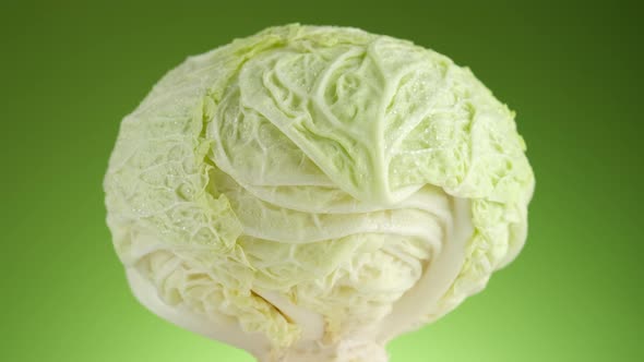 Savoy cabbage isolated on green background, rotate. Healthy food concept. 4K UHD video alt