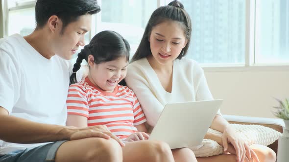 Asian family mom dad daughter laugh smile spending weekend alt