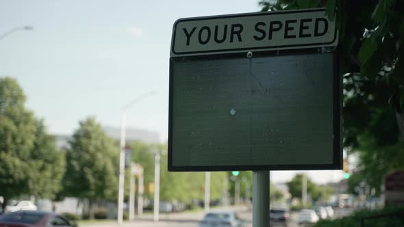 Close up of digital speeding sign telling drivers how fast they are driving. Daylight. alt