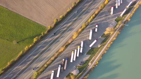Top down aerial view of highway interstate road with fast moving traffic and parking lot with alt