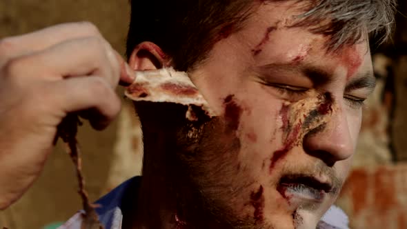 Zombie Head Close Up. Portrait of Scary Bad Zombie at Night with Bloody Skin. alt