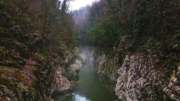 Flying Over a River Through a Narrow Canyon with White Rocks Sochi alt