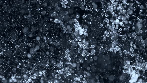Super Slow Motion Shot of Splashing Water on Black Background at 1000Fps. alt