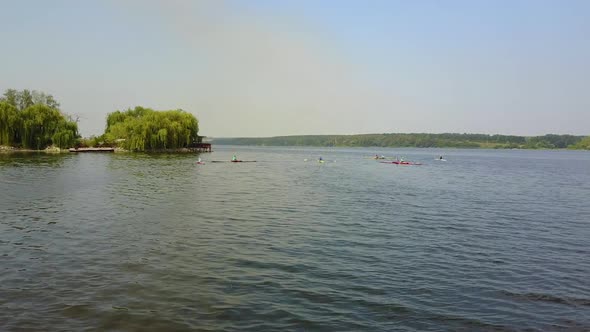 Young Children Kayaking On River. People in boat rowing in kayak over the river alt