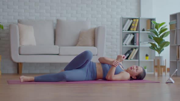 Asian woman practice yoga plank online course at home sudden injuries Wrist pain alt