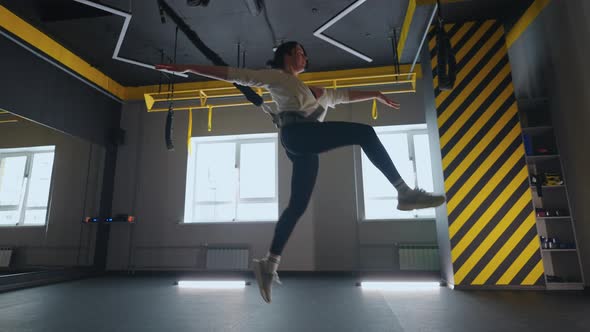 Sporty Woman is Training in Gym with TRX System Sport Activity and Tensing Muscles Caring About alt