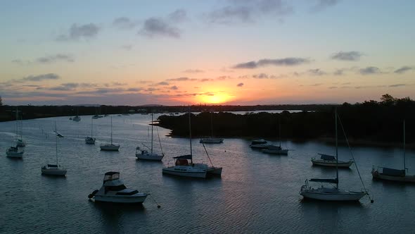 Beautiful sunset of boats on a river. Aerial drone shot Australia, New South Wales, Yamba alt