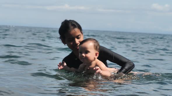 Swimming in the Sea is a Good Wellness Procedure for a Mother with a Child