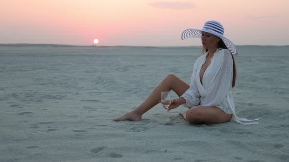 Stylish Woman in Hat Relaxing on Beach