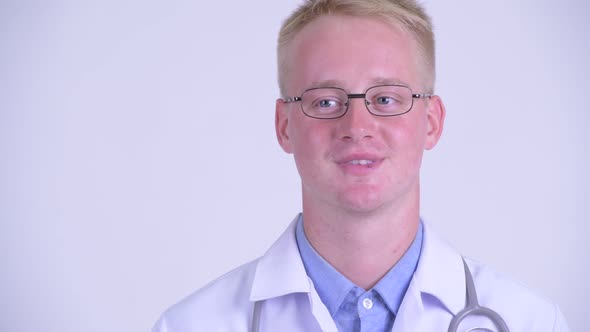 Face of Happy Young Blonde Man Doctor Thinking alt