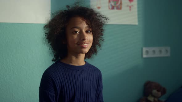 Portrait Smiling African Girl Sitting Modern Clinic alt