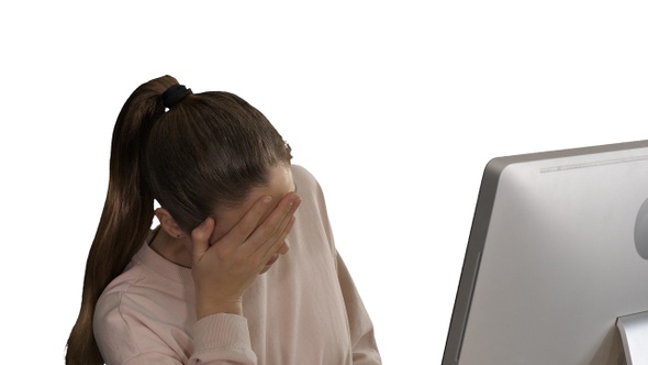 Tired Cute Casual Woman at Her Computer on White Background alt
