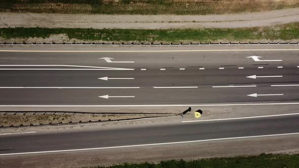Directy Above Close Up of Road, Asphalt, White Arrow Signs Indicating Direction, Way of the Highway alt
