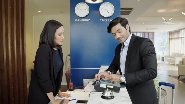 The guest is using a credit card with the edc machine to pay for services alt