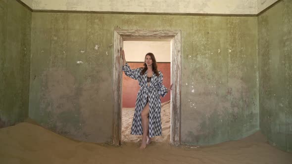Young Woman in Dress and Underwear in Abandoned Building Posing in Room