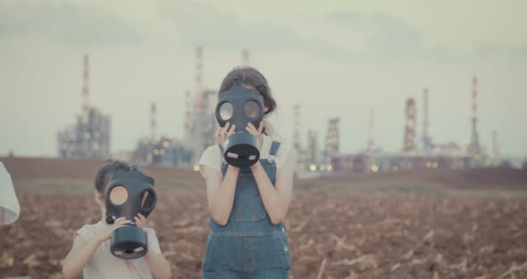 climate change crisis. Kids wearing gas masks near an oil refinery alt