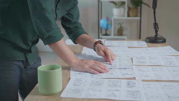 Creative Designer Works On A Storyboard, Looks At His Sketches And Concepts alt