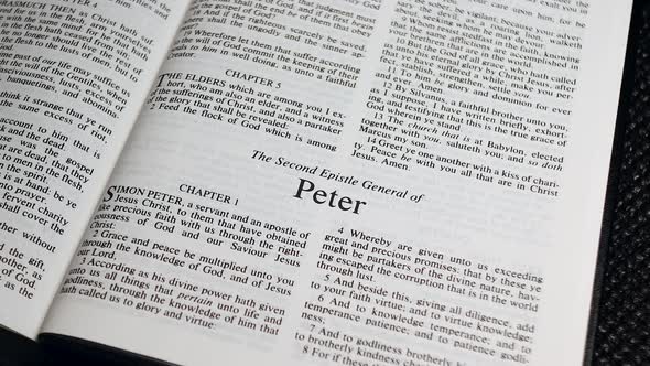 Close Up Shot of  Bible Page Turning to the book of Second Peter alt
